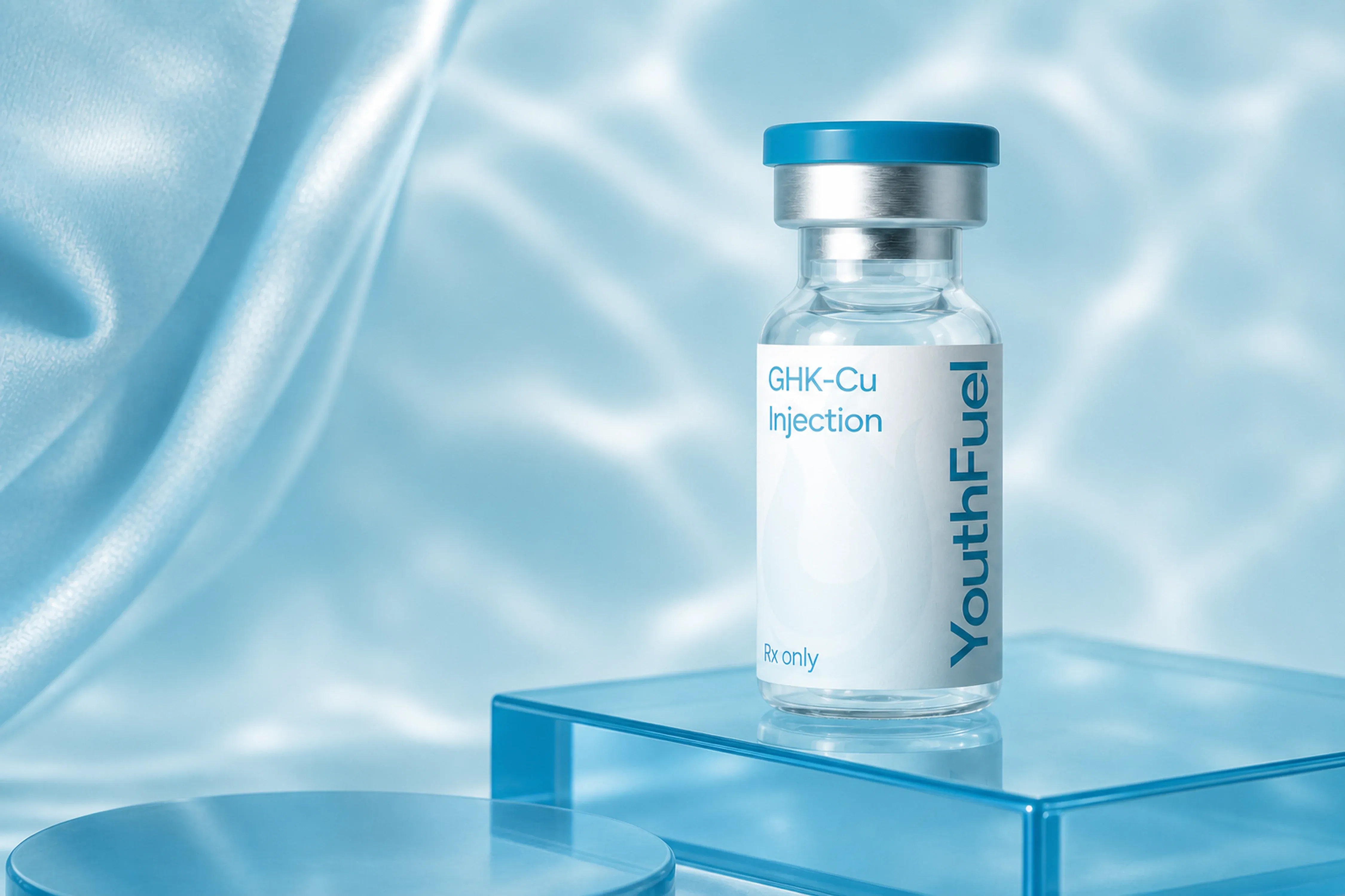 YouthFuel GHK-CU injection vial on a clear pedestal with aqua light.